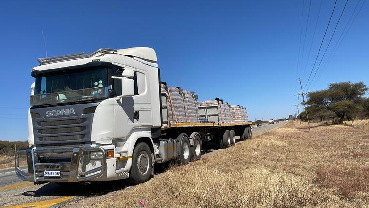 Super Link flat deck truck loaded with cement bags